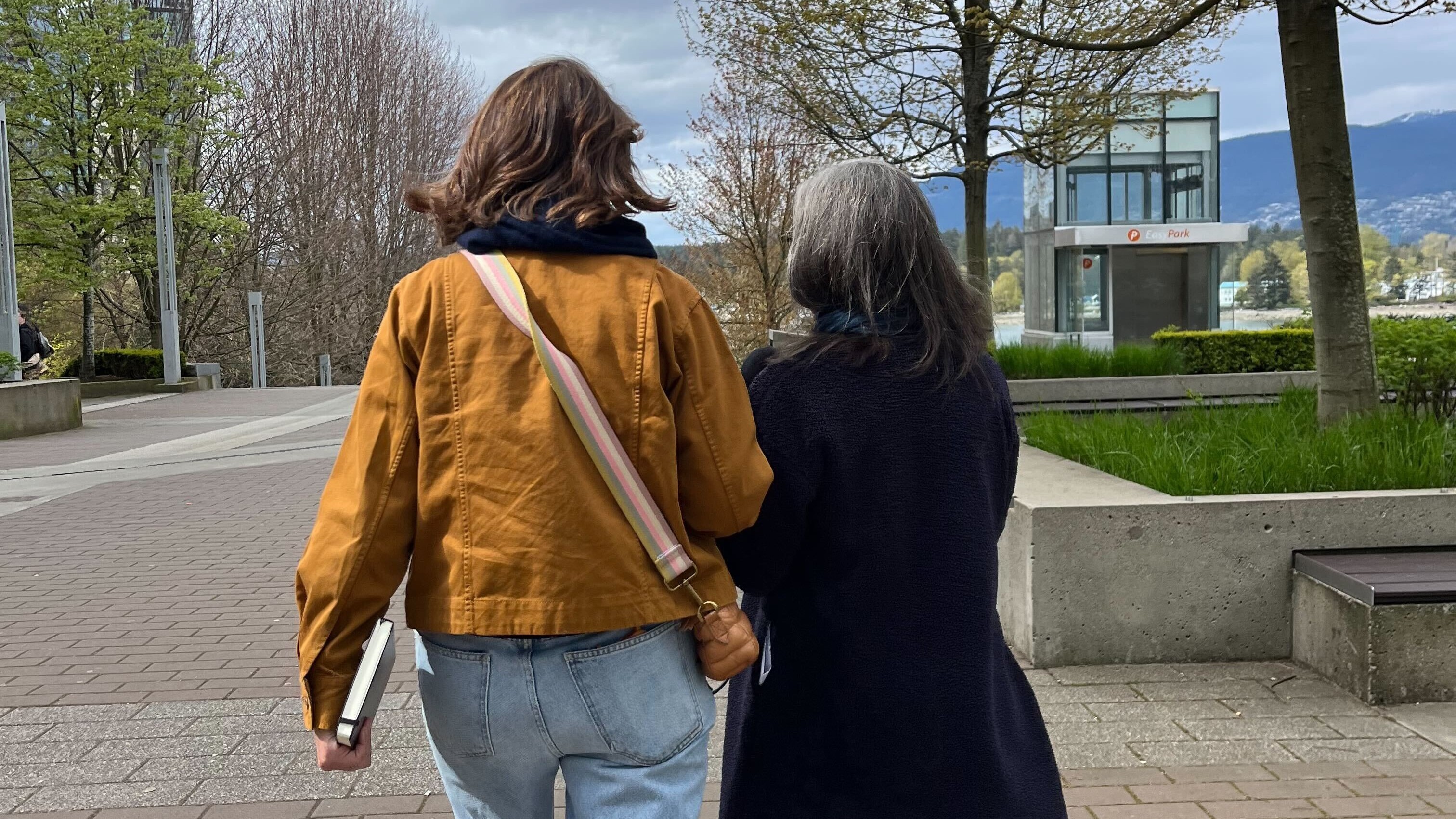 Author Kelly Corrigan(left) and Manoush Zomorodi(right) on a walk around Vancouver. Corrigan has her notebook at the ready.